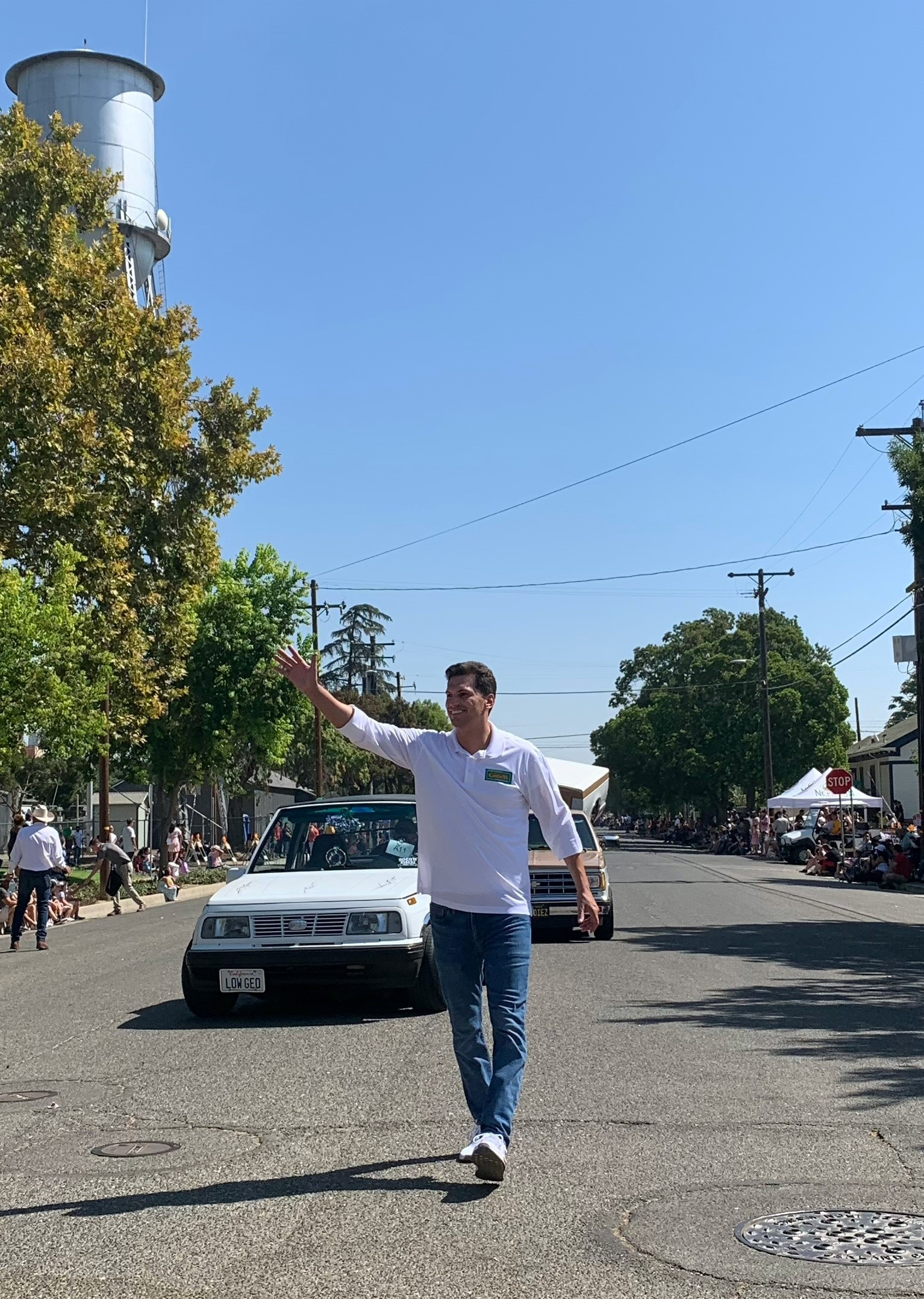 Channce Condit walking in front of a car during the Newman Fall Festival Parade in 2021