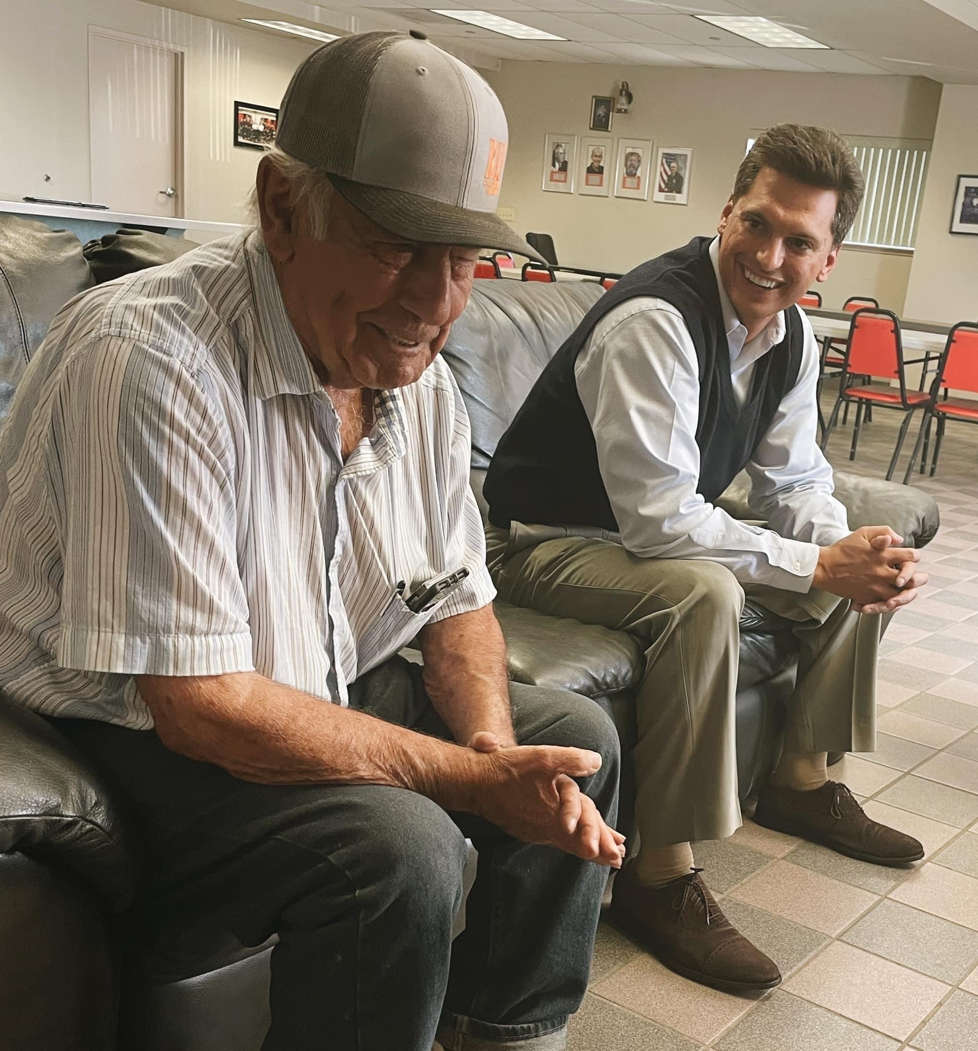 Channce Condit sitting on a couch talking to a man during the Westley District Office Hours in 2022